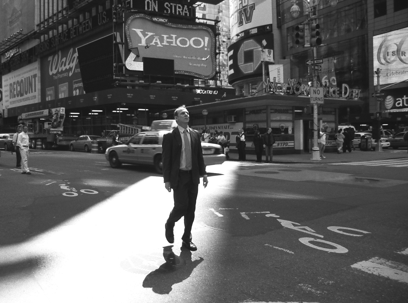 Man wandering through Times Square, NYC.
